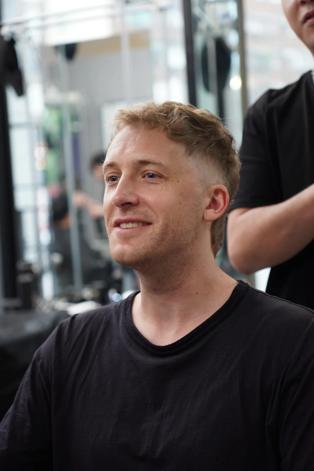 A client smiling in the salon chair