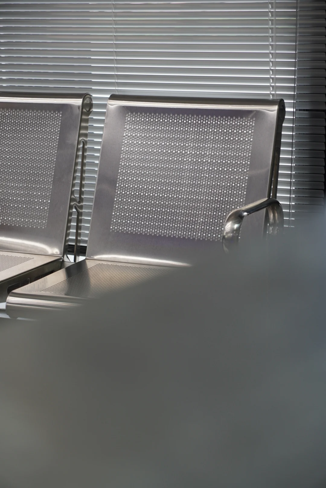 Daylight across a chair and wall beside the window