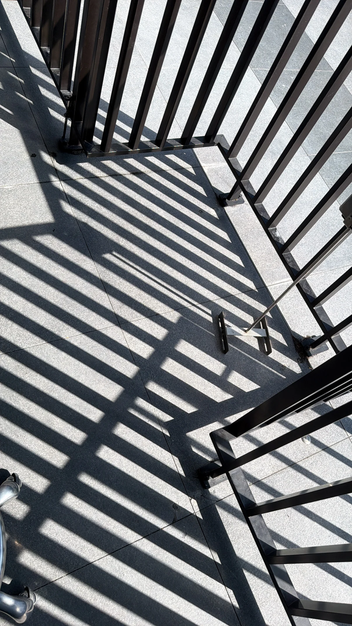 Striped shadows across the floor and a chair